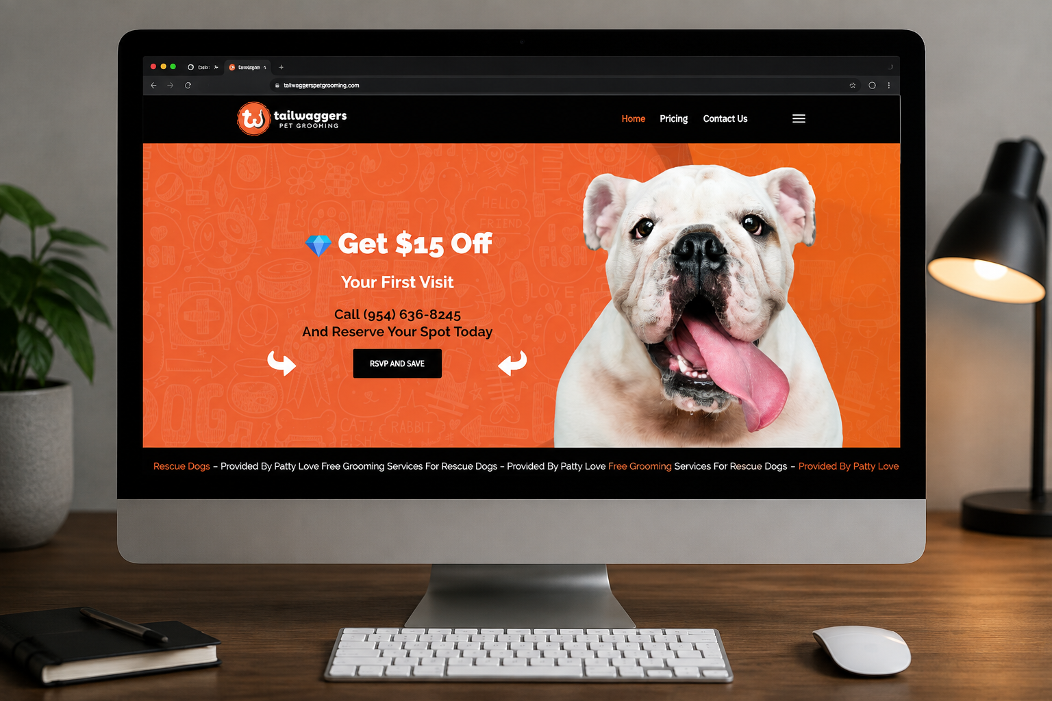 Homepage of a pet grooming site on a computer monitor with an orange banner and a white bulldog on the right side, promoting a $15 off first visit offer