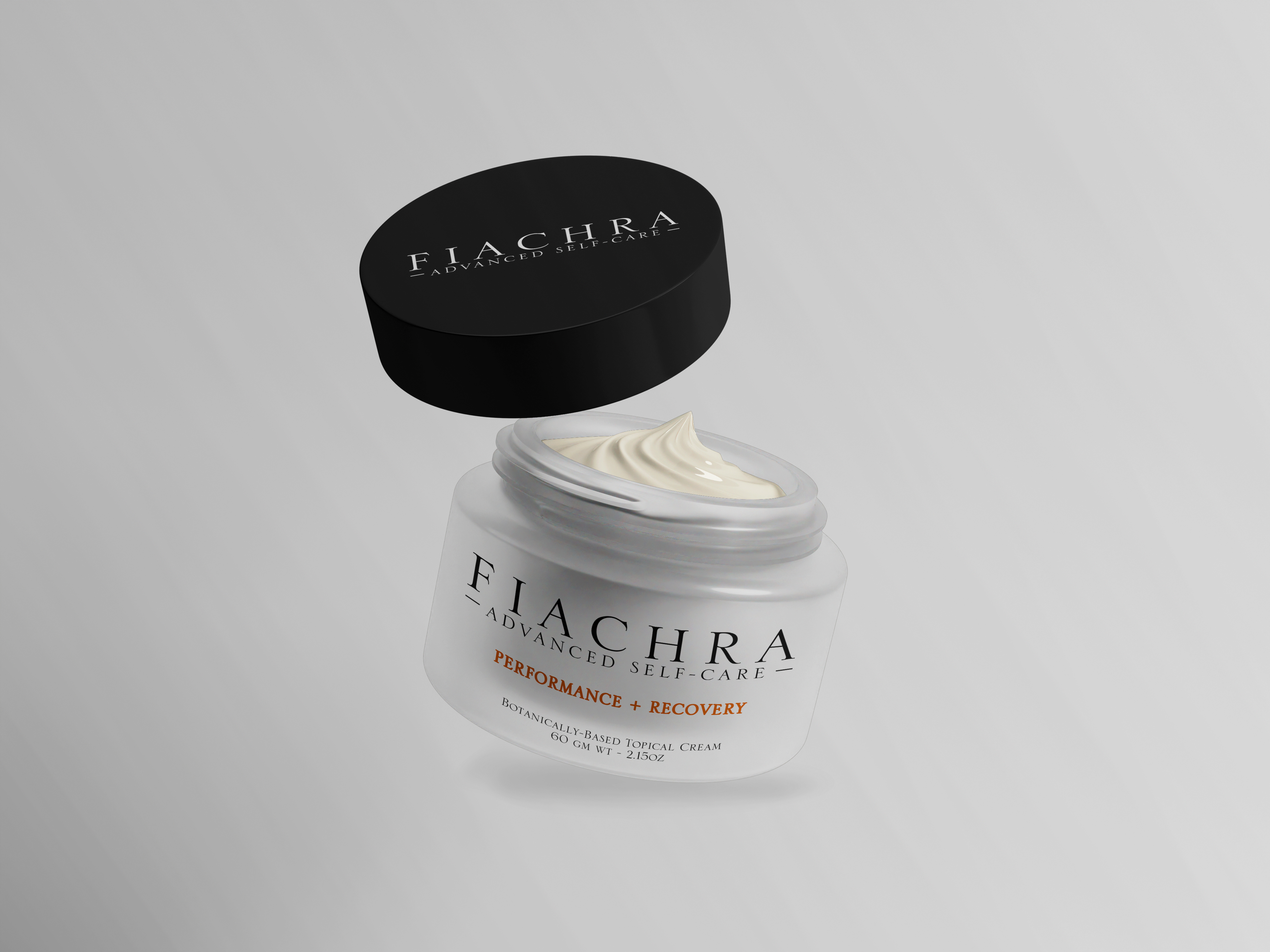 Black round cosmetic jar lid reading FIACHRA Advanced Self-Care, opened to reveal pale cream.