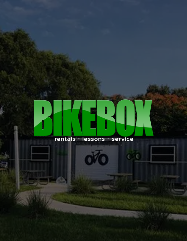 BIKEBOX logo in bright green over a bike rental shop exterior.