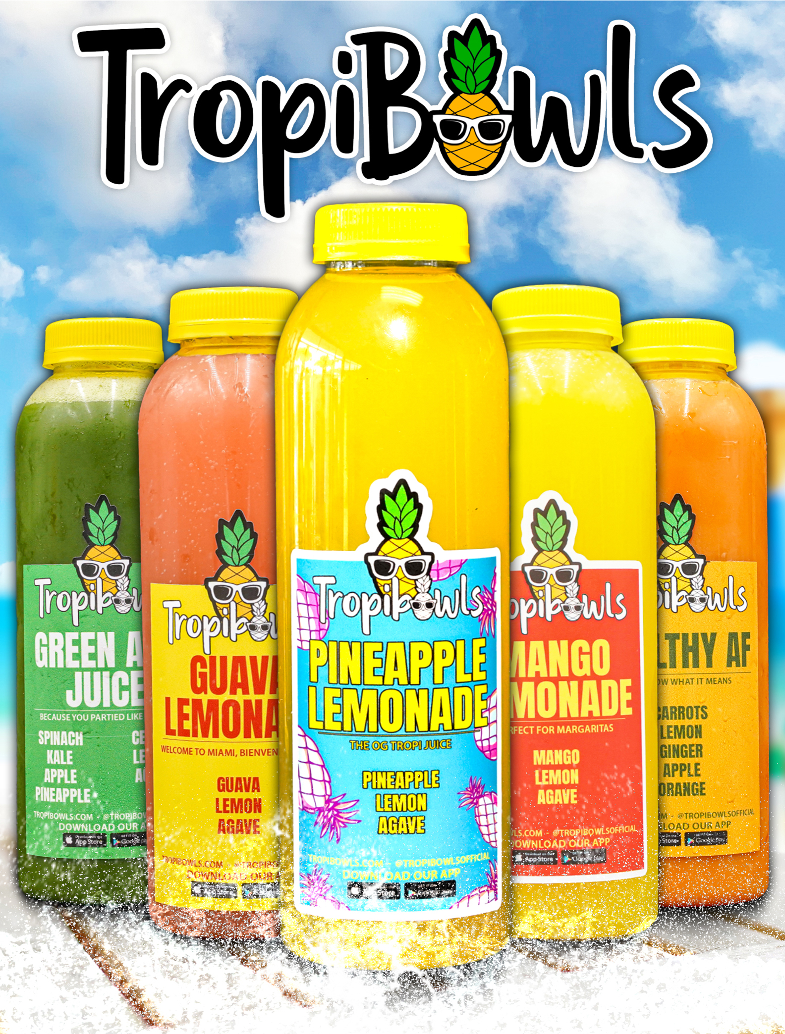 Bright TropiBowls juice bottles lineup with colorful labels—green, pink, yellow, orange, blue—under a blue sky with clouds.